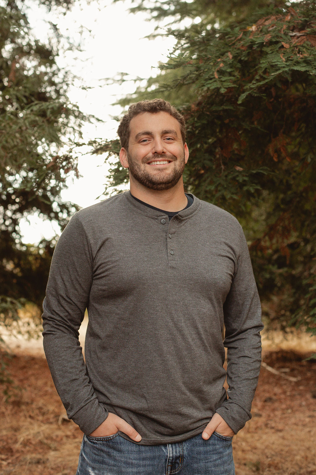 Man wearing Dark gray Happy Henley long sleeve tee. Plain front with 3 buttons