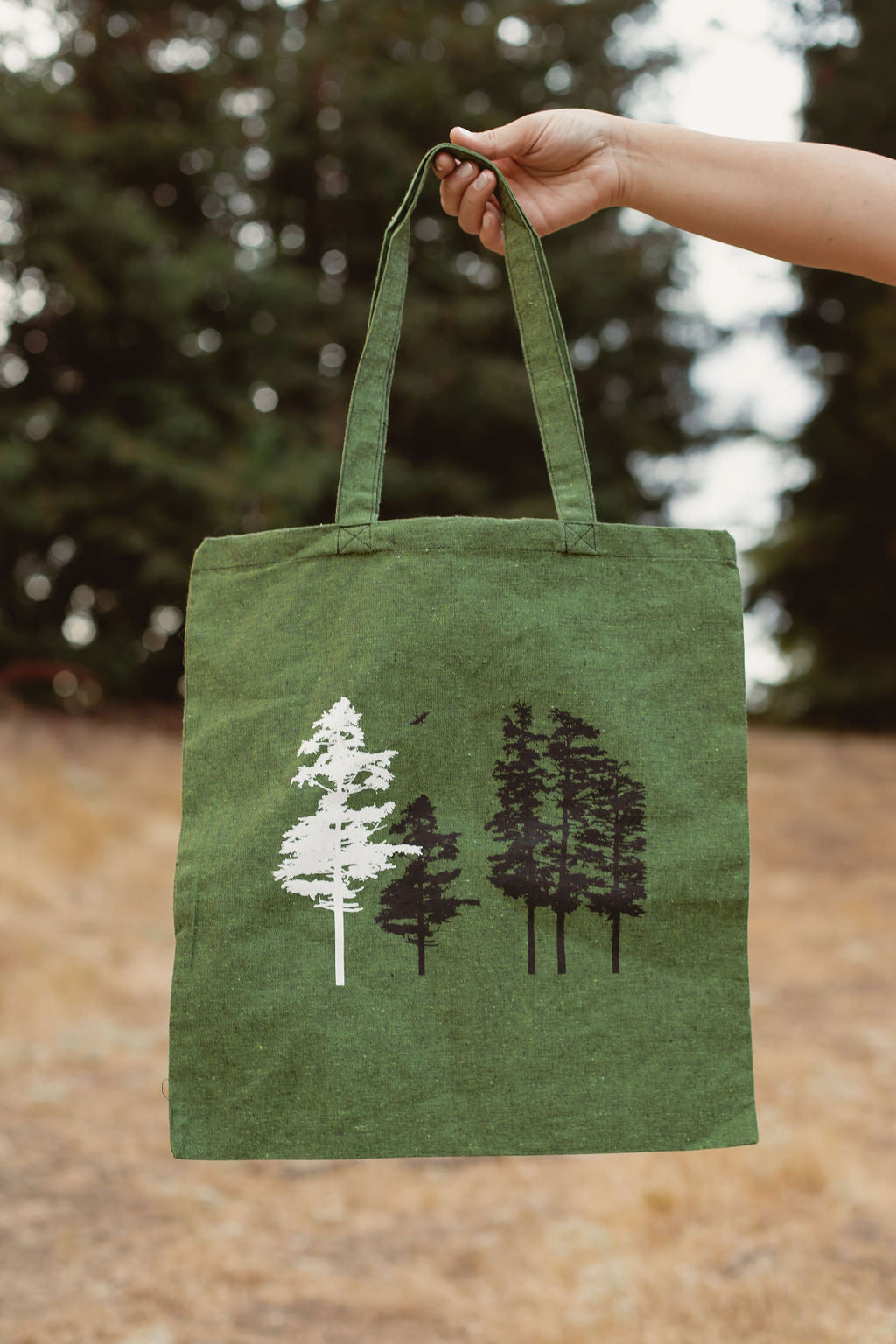 Green canvas bag with white and black tree stamps