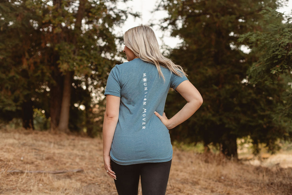 White Mountain Mover text on the back of a blue t-shirt
