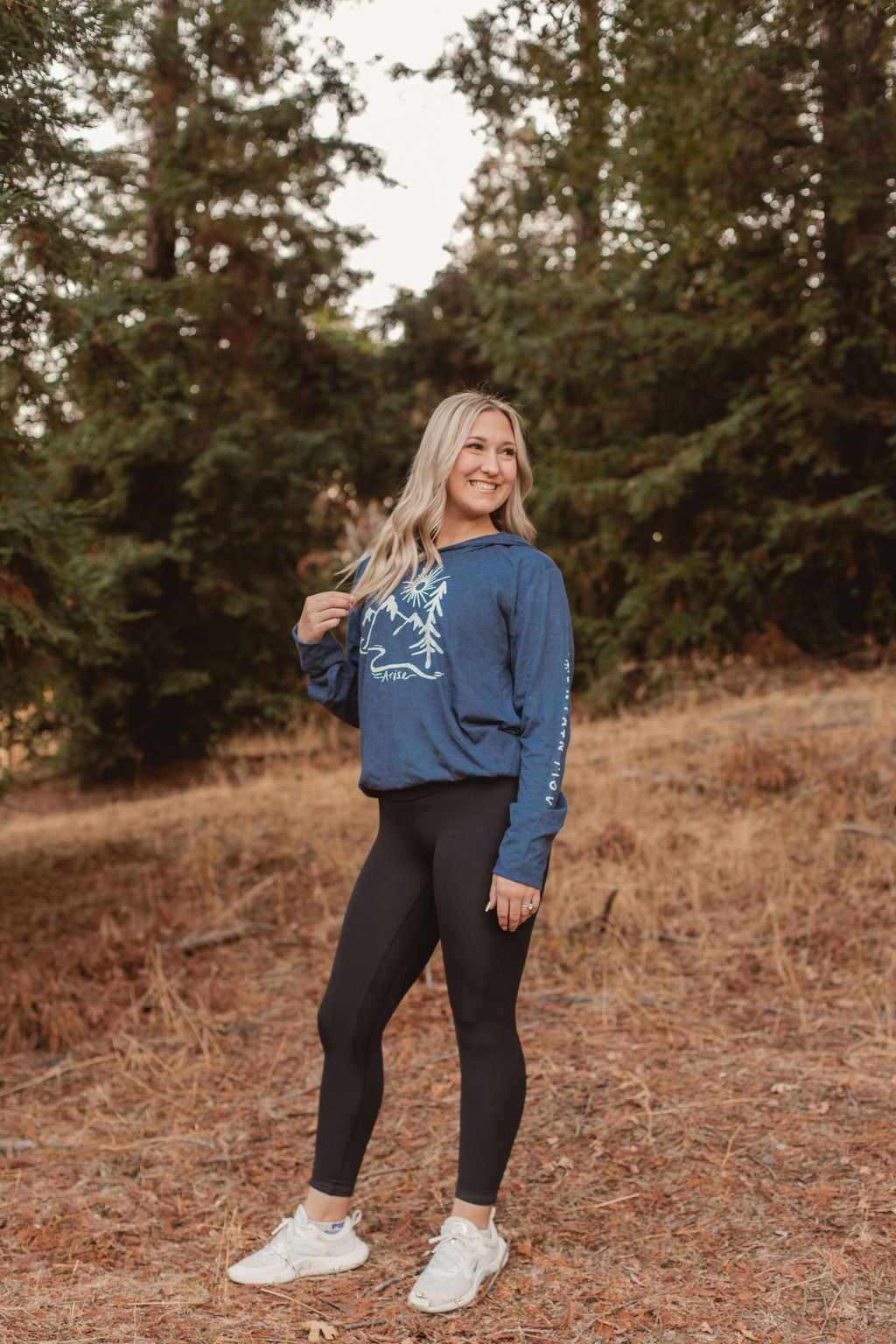 woman wearing dark blue arise hooded tee