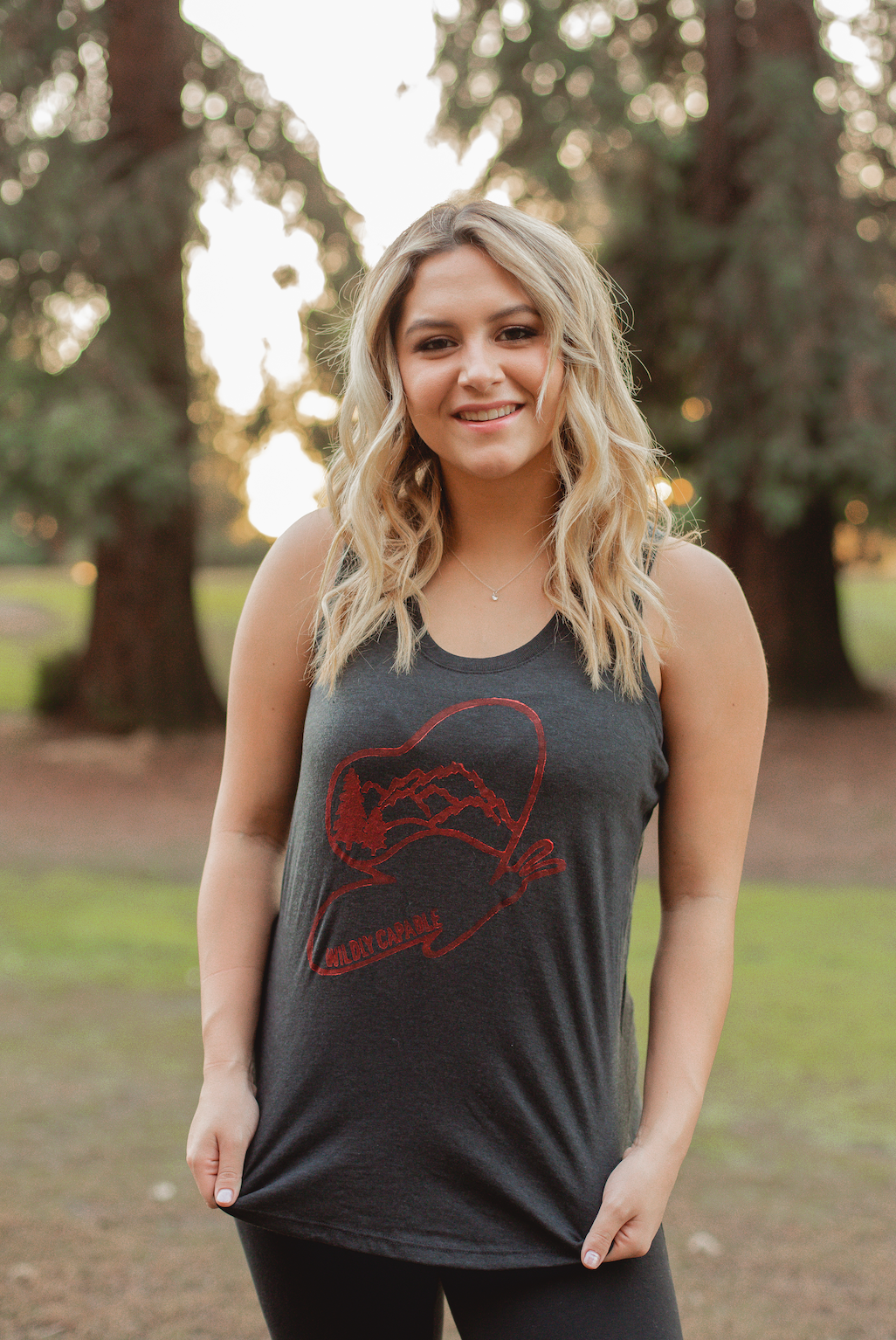 dark gray tank top with red butterfly "wildly capable" logo on it