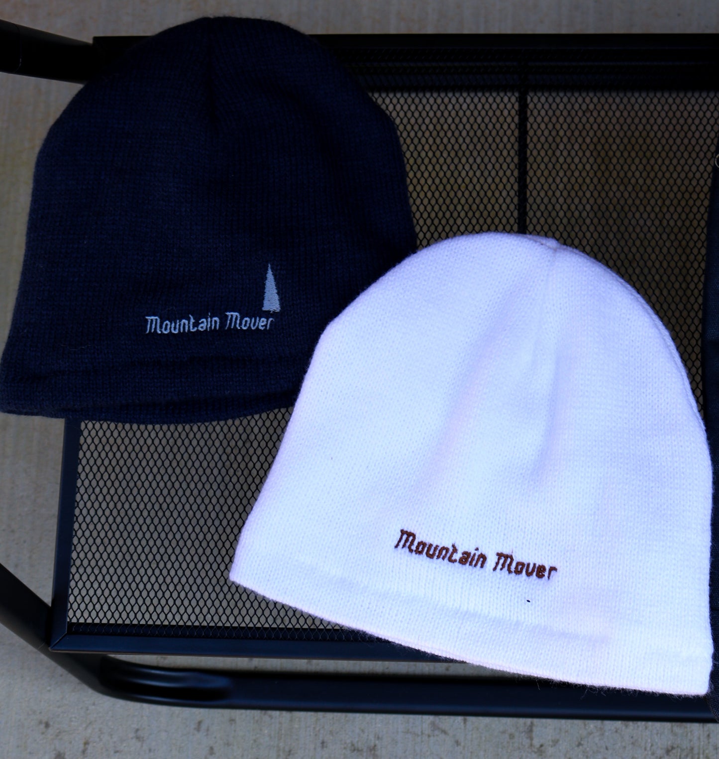 White and navy beanies with mountain mover embroidery