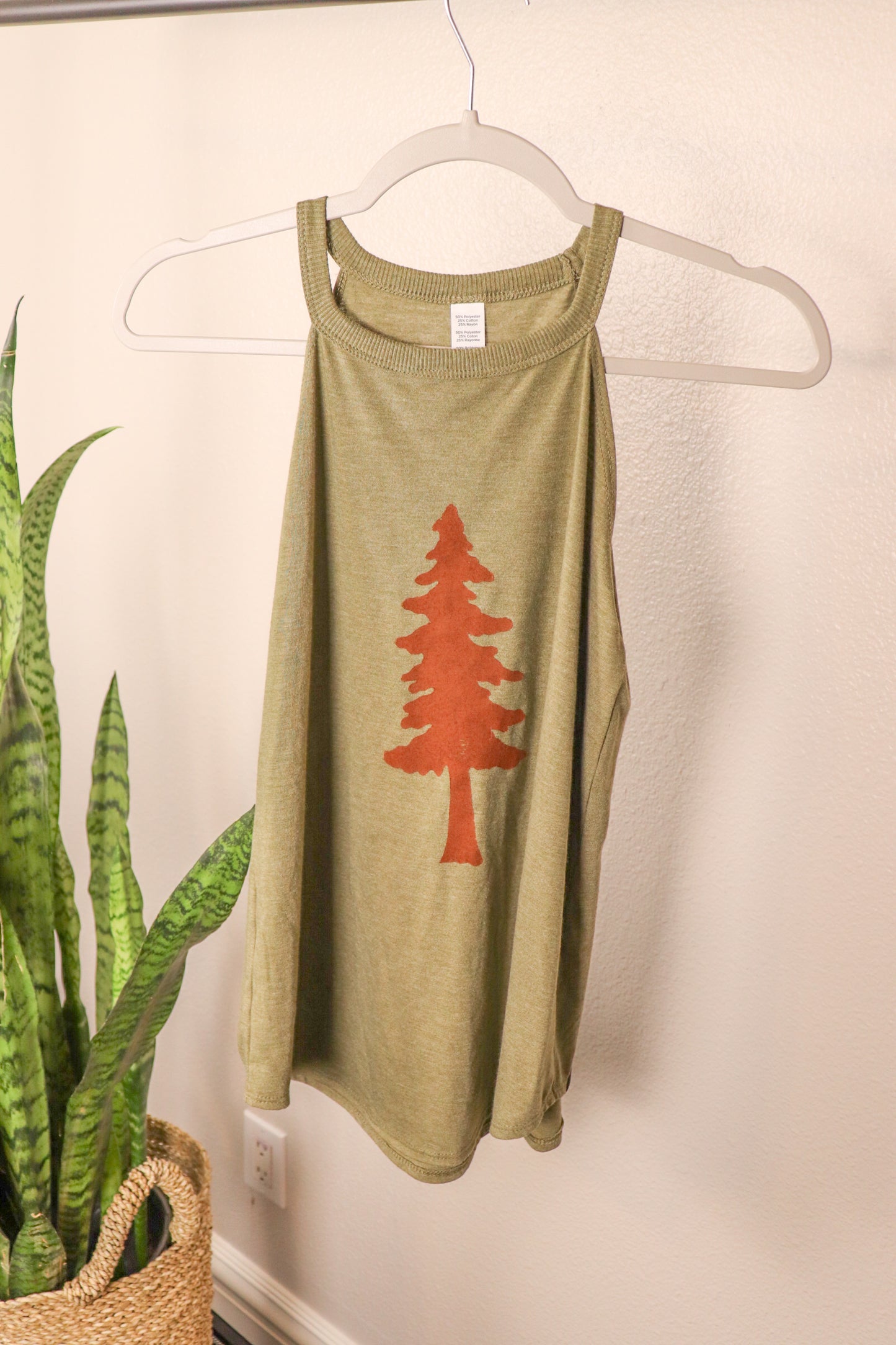 front of green tank with tree stamp