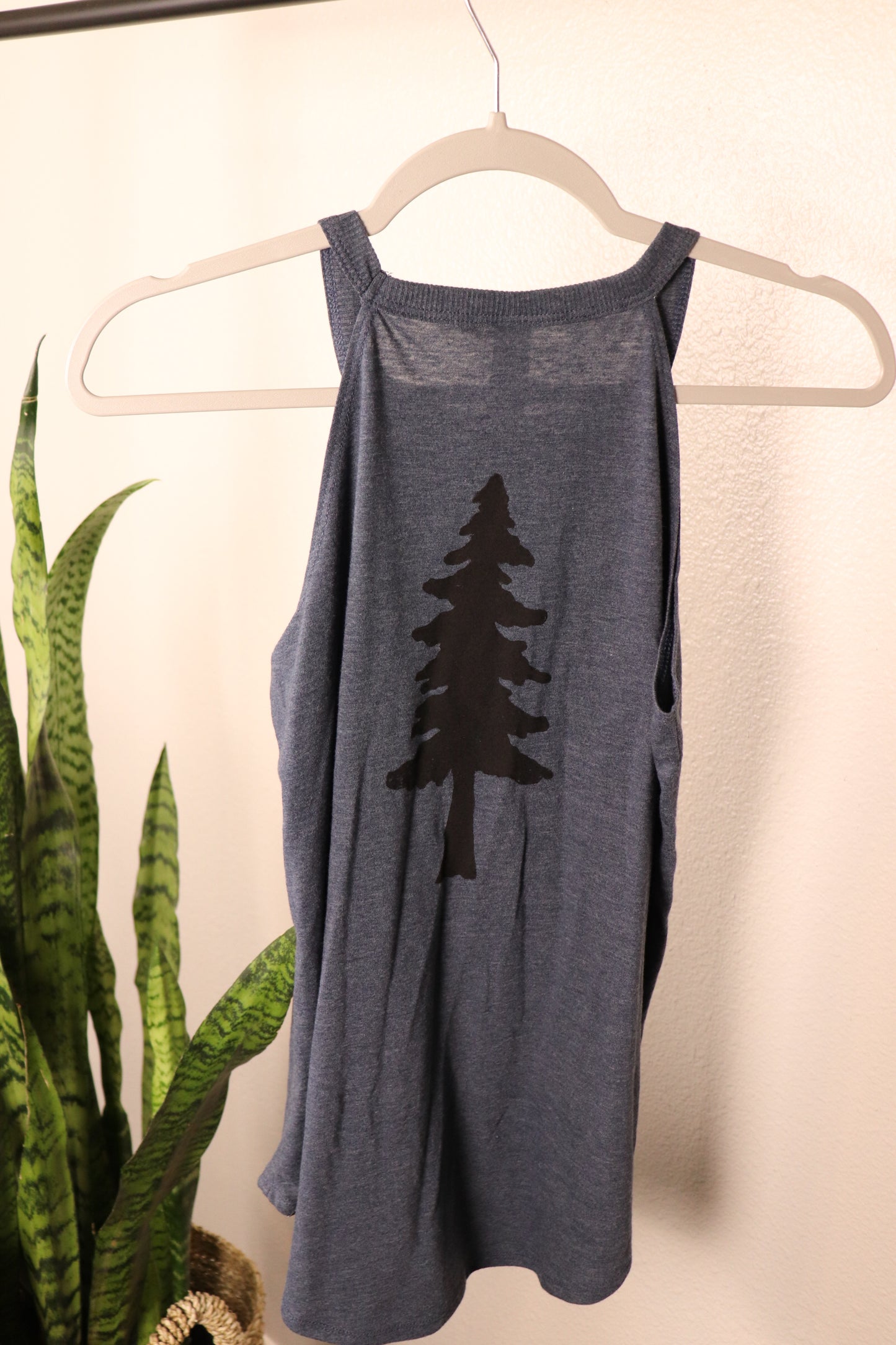 back of navy blue tank top with black tree stamp