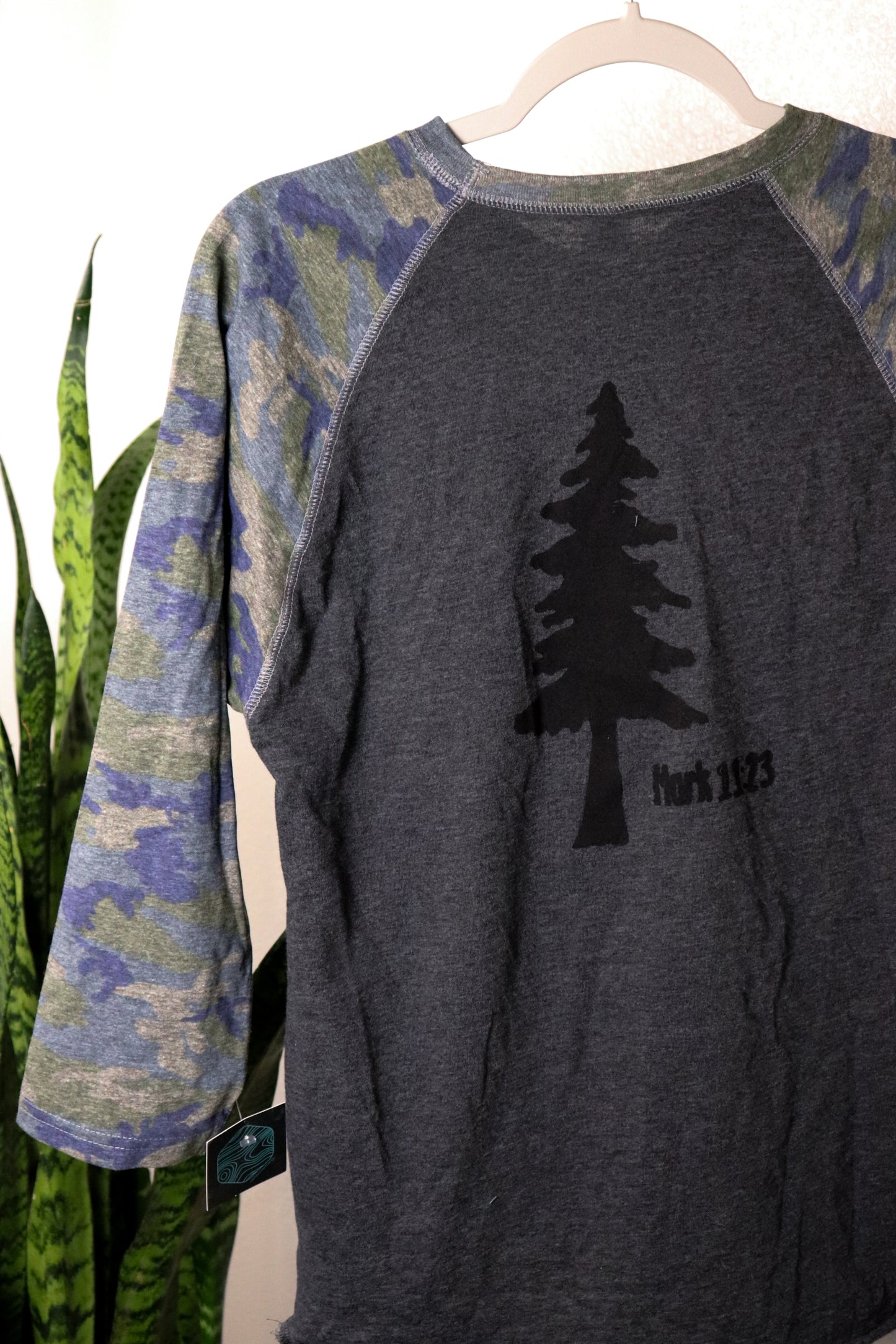 Gray T-shirt with 3/4 camo sleeves and black tree stamp with mark 11:23