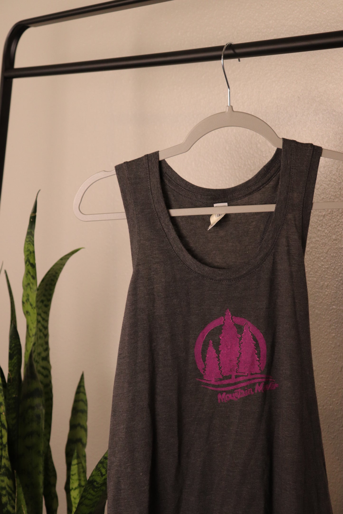 Gray tank top with pink stamp showing three trees with mountain mover text beneath
