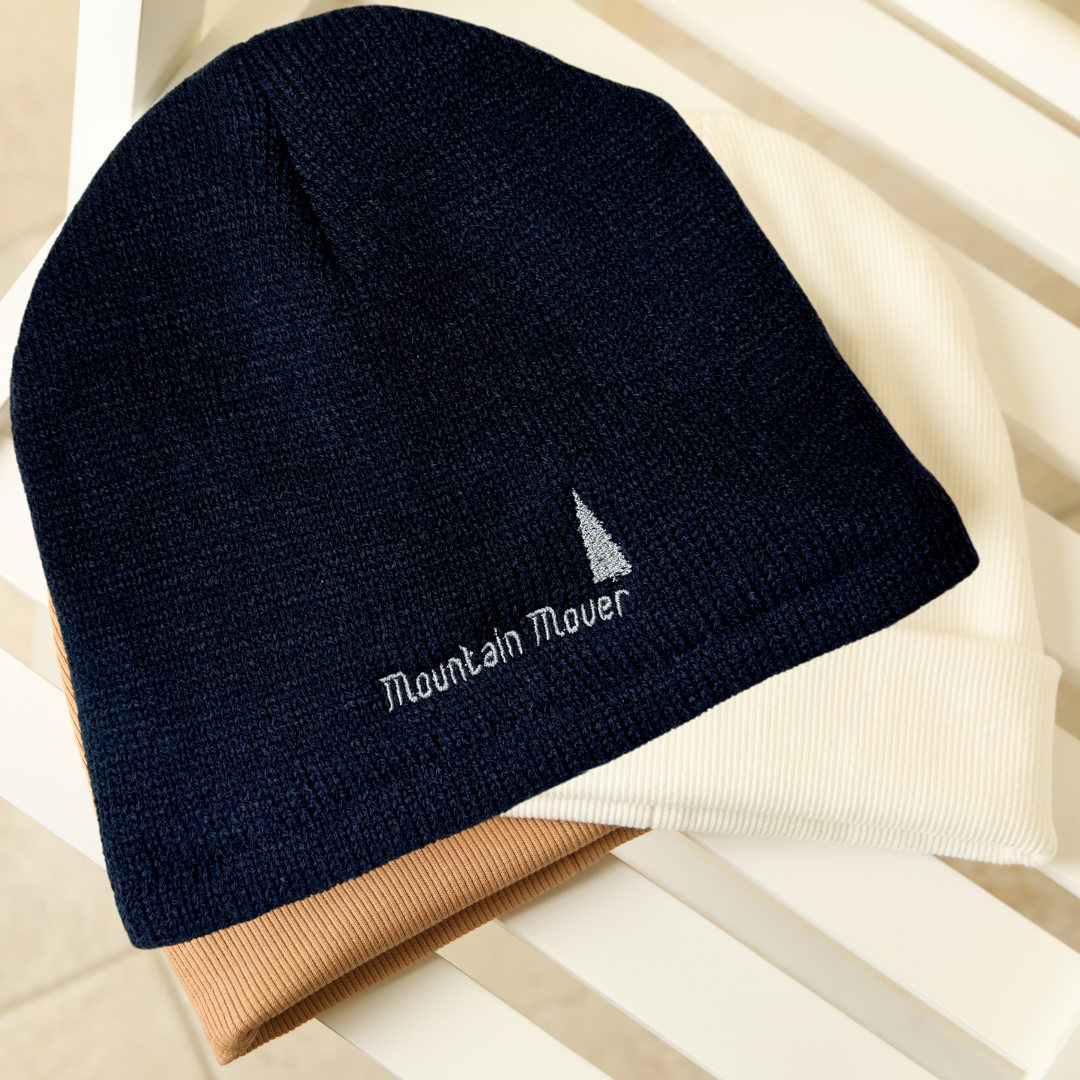 Navy blue beanie with white mountain mover embroidery
