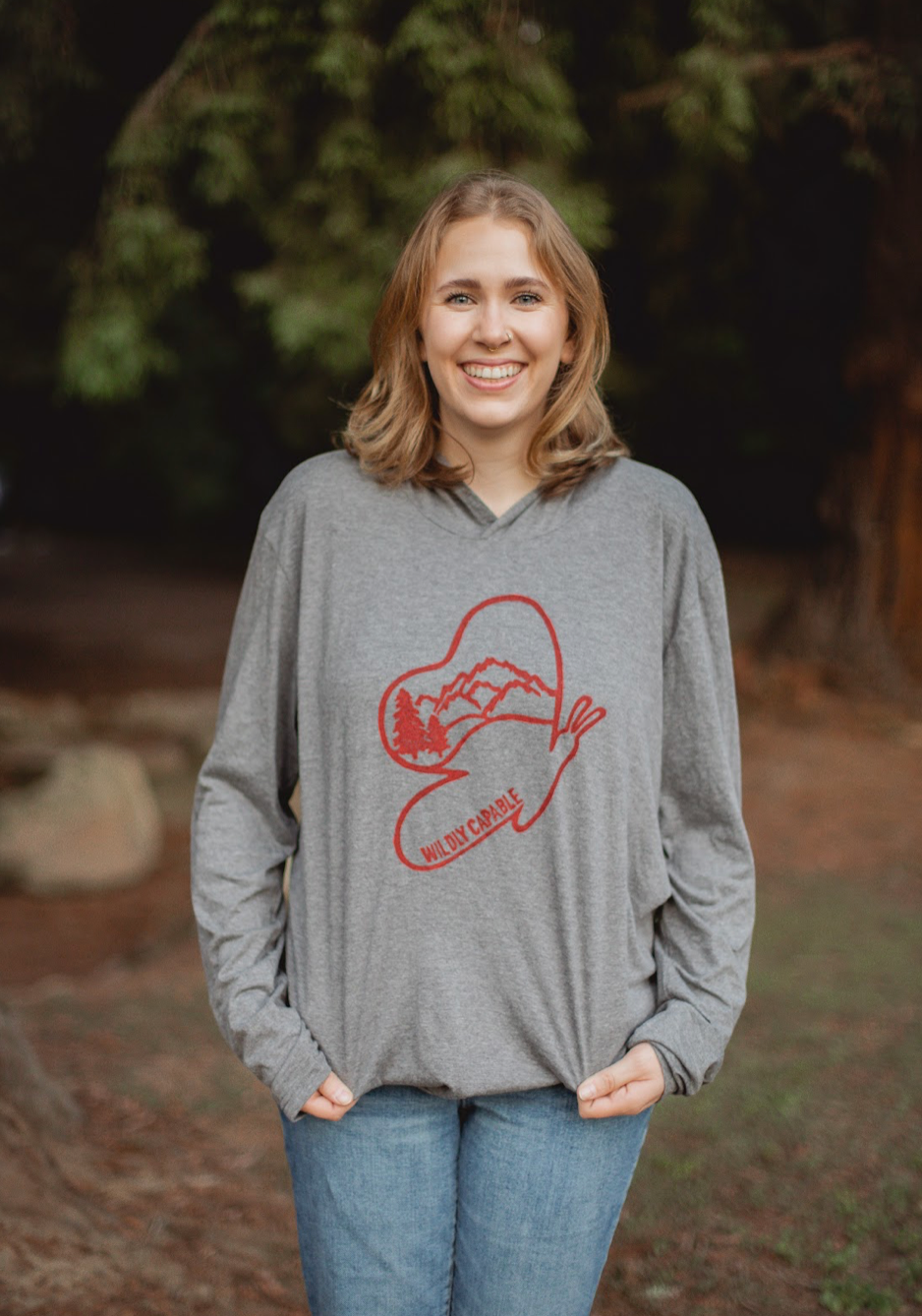 Woman in Light gray hooded long sleeve shirt with red wildly capable butterfly stamp