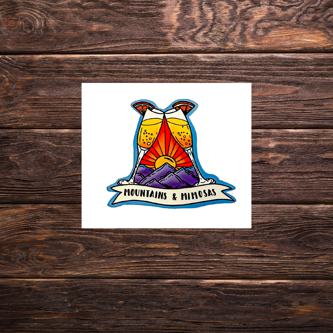 “Mountains and mimosas” sticker with sunrise and two mimosa glasses